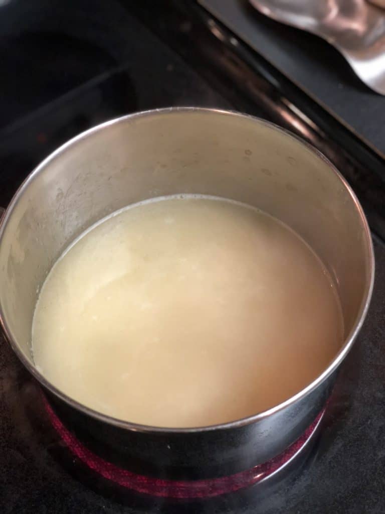 broth in pot with rice for risotto