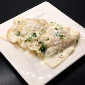 crab ravioli on a white plate