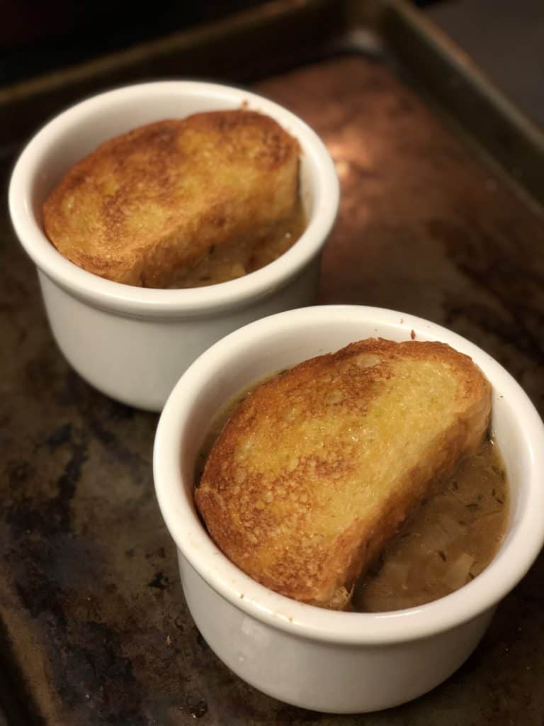 soup with toast in white bowls