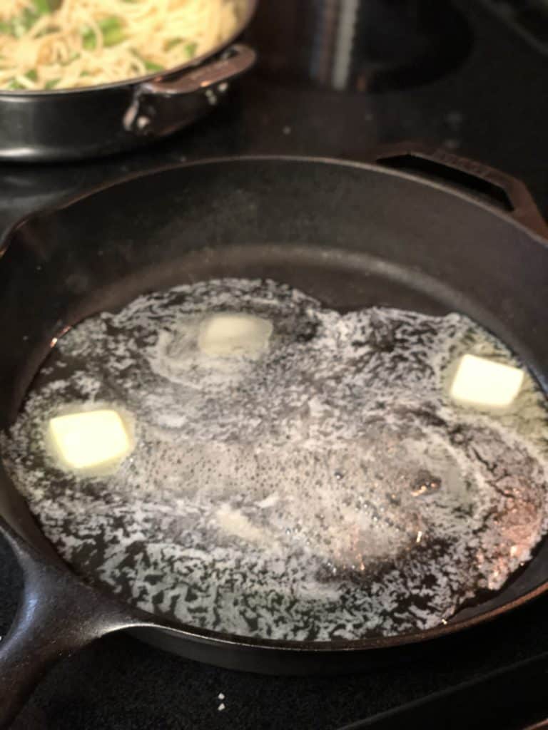 butter melting in a cast iron pan