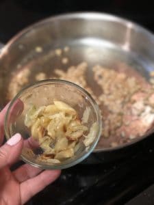 a glass bowl of roasted garlic