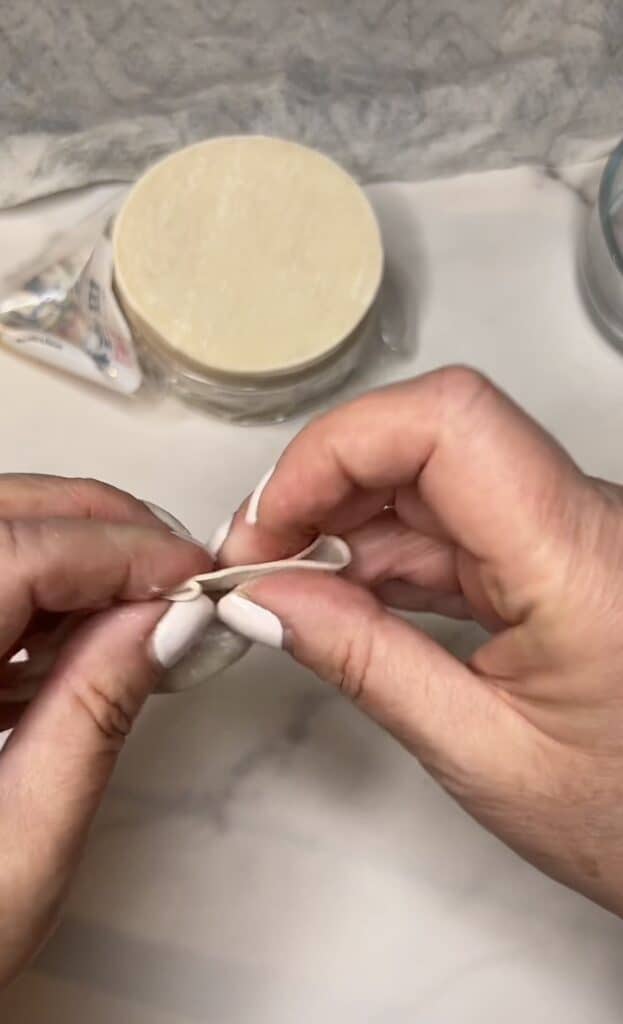 Me showing how to pleat dumpling wrappers