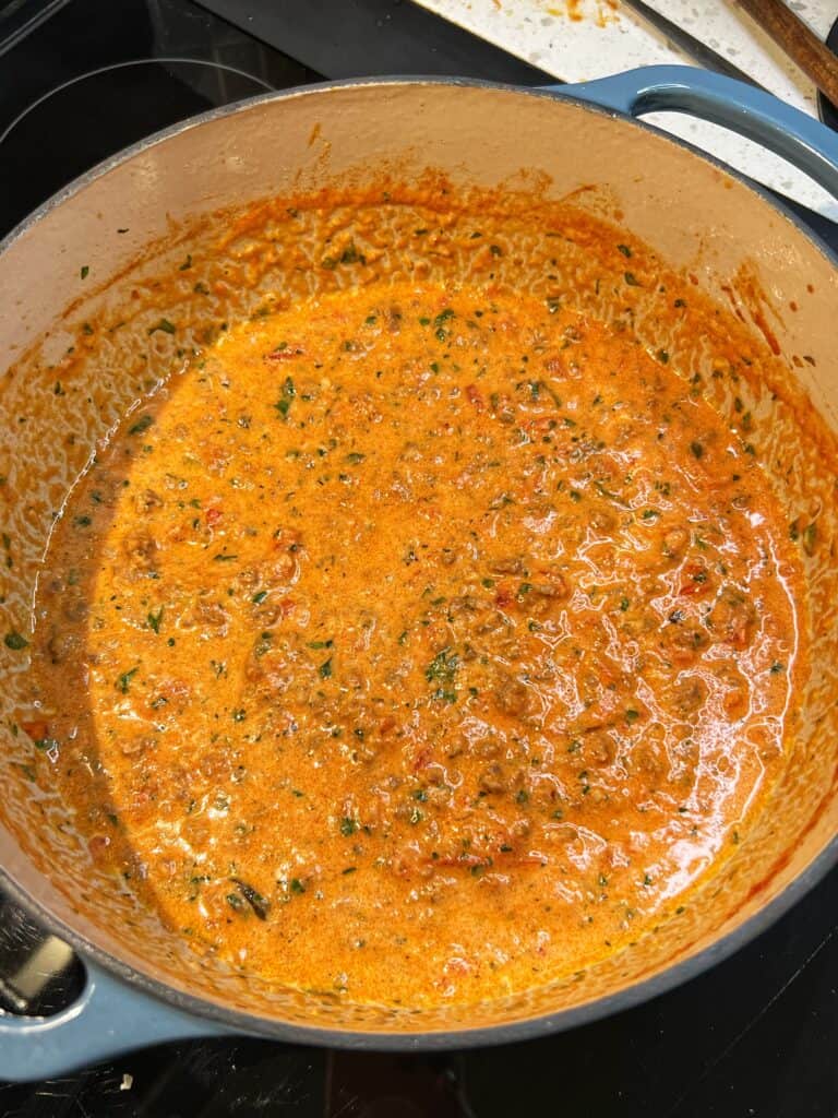 A large pot of spicy sauce cream sauce. The sauce has an orangish hue.