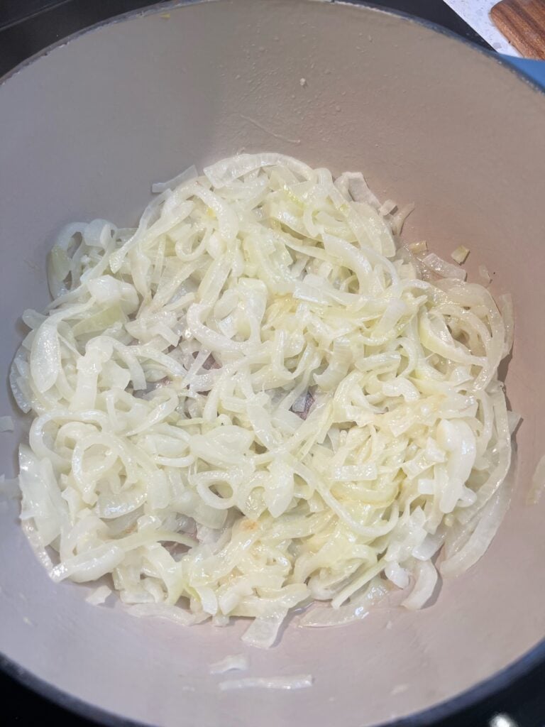 Sautéing sliced onions in a pot. This is what they look like after 20 minutes. Barely starting to caramelize.
