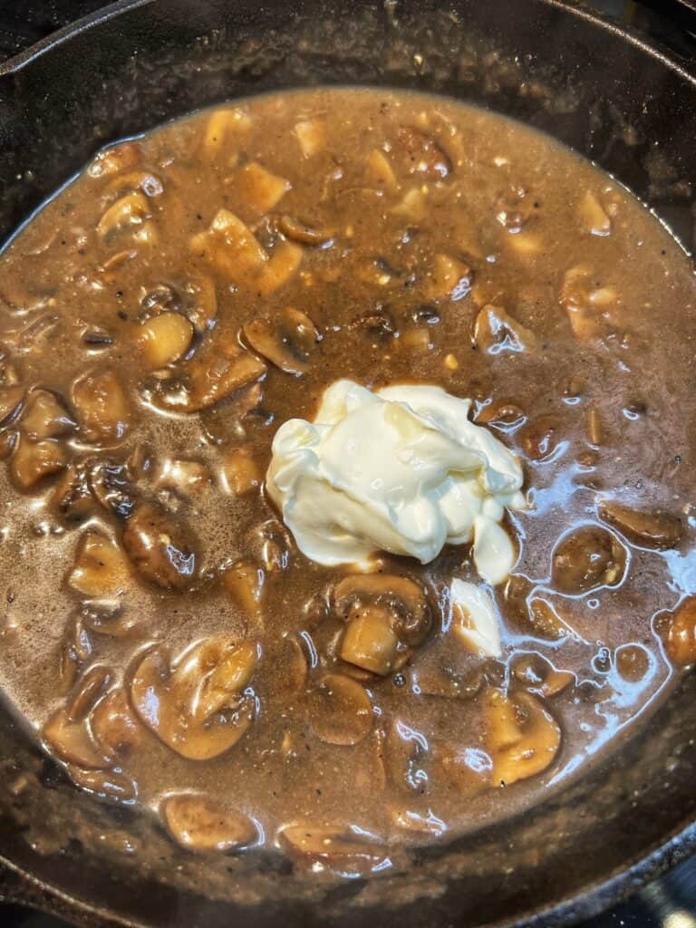 A few dollops of sour cream in mushroom gravy for beef stroganoff.