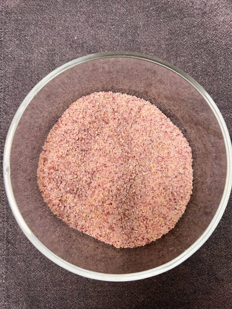 A cup of unicorn grits in a glass bowl.