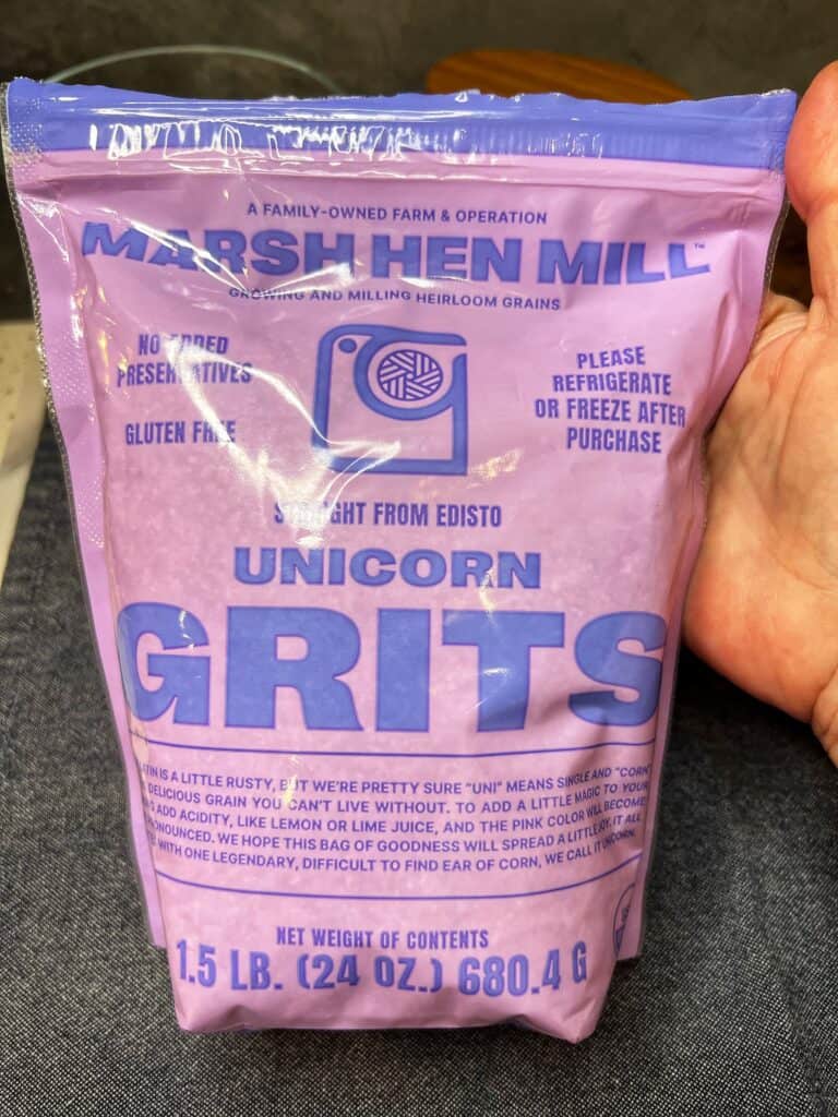 Me holding a two-pound bag of Marsh Hen Mill Unicorn Grits.