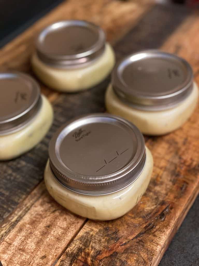 four mason jars filled with egg custard with lids on