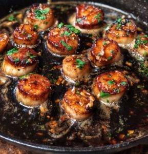a pan of honey garlic scallops in brown butter
