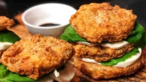 fried green tomato stacks on a wooden platter