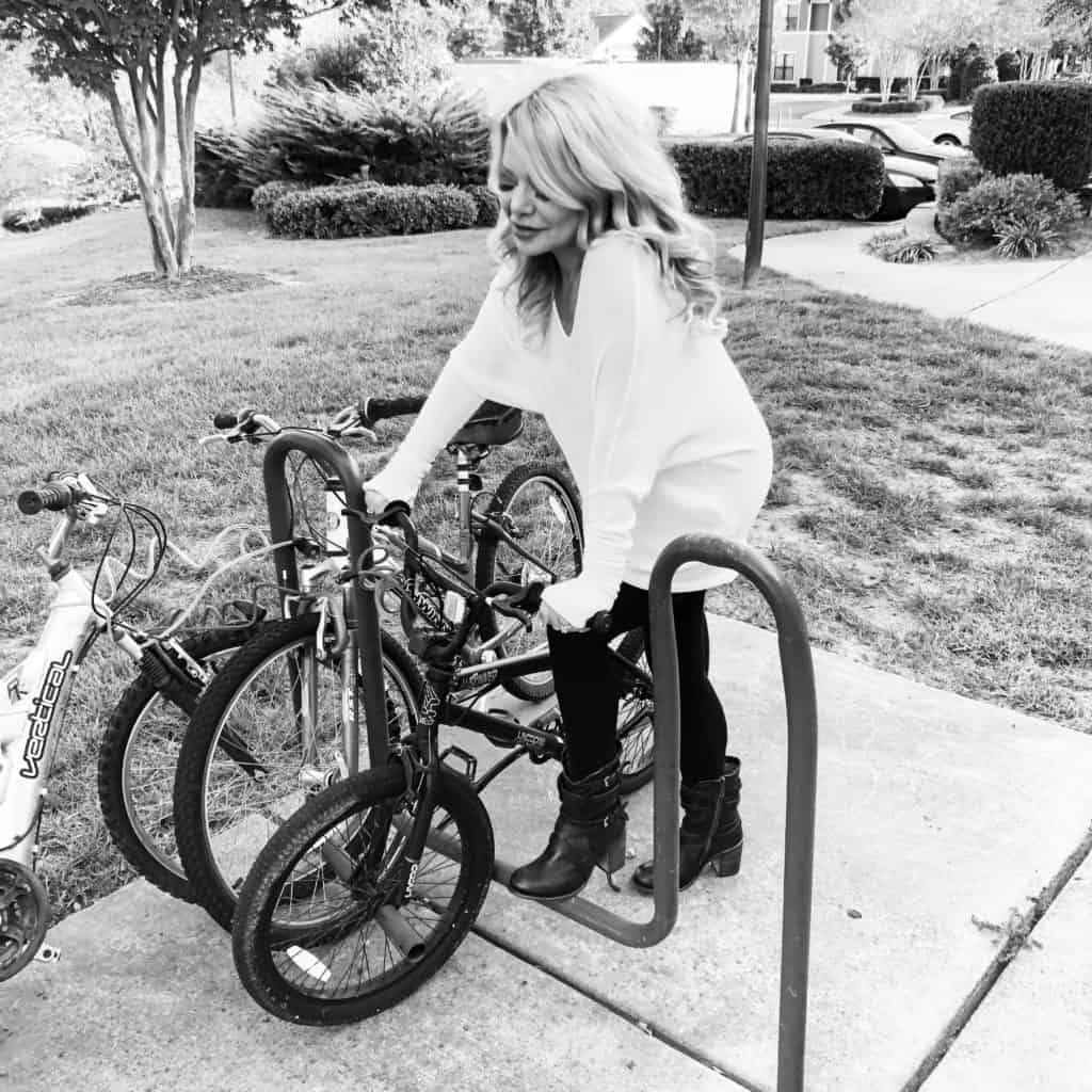 me wearing a maru sweater sitting on a bike