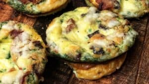 five egg muffins displayed on a board