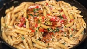 a cast iron pan full of cajun chicken pasta