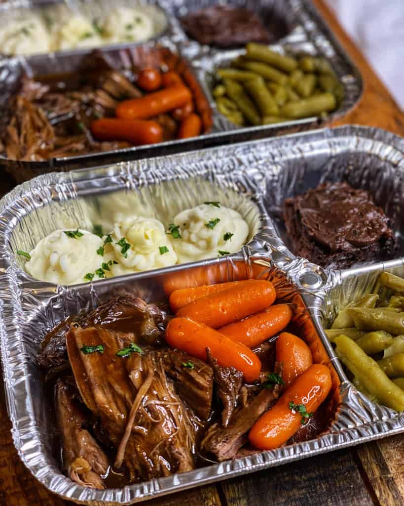 Beef pot roast tv dinner with mashed potatoes, a brownie, and green beans.