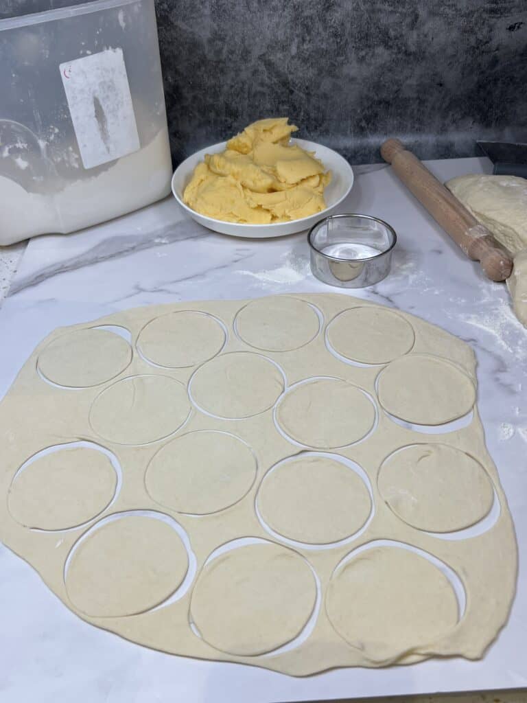 Pierogi dough cut into circles.