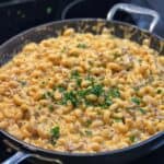 A pan of Homemade Cheeseburger Hamburger Helper garnished with fresh parsley.