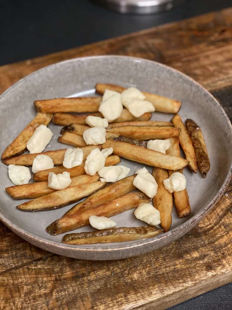 a plate of french fries and cheese curds