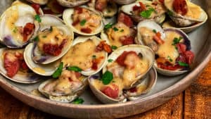 a bowl of Clams with Crispy Country Ham and Maple Apple Foam