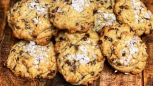 salted chocolate chip cookies displayed on a wooden board