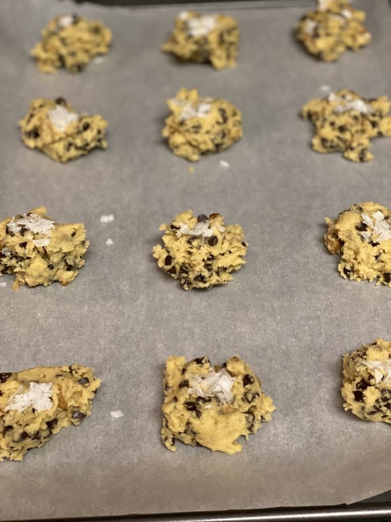 salted chocolate chip cookie dough topped with flake salt ready to bake