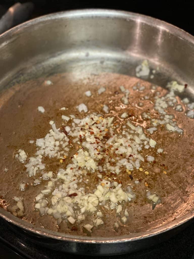 minced garlic and shallots softening in a pan