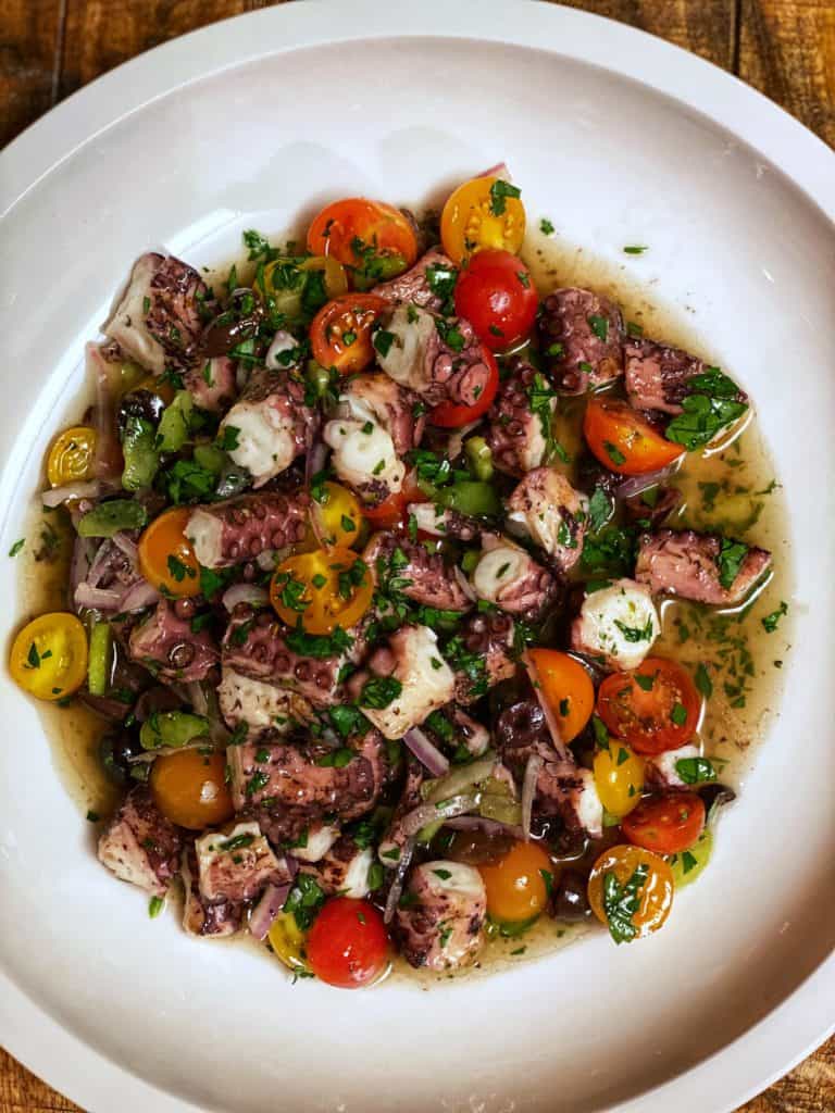 a white bowl of Grilled Octopus Salad