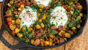 a breakfast skillet on a wooden board