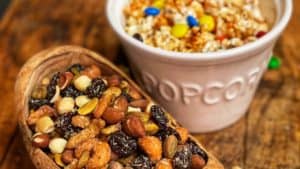 a bowl of mixed nuts and a bowl of popcorn for my party snack ideas blog