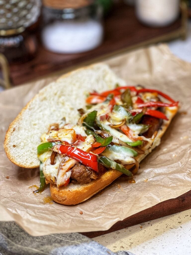 A long roll filed with Italian hot sausage and peppers with melty cheese on the top.