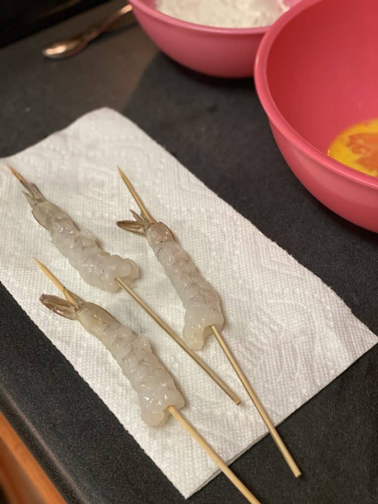 three skewered shrimp