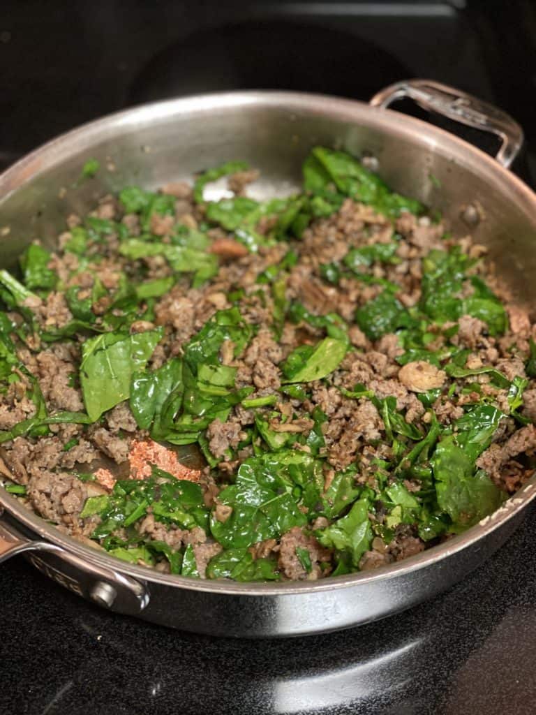 a mixture of sausage and chopped spinach for stuffed portabella mushrooms
