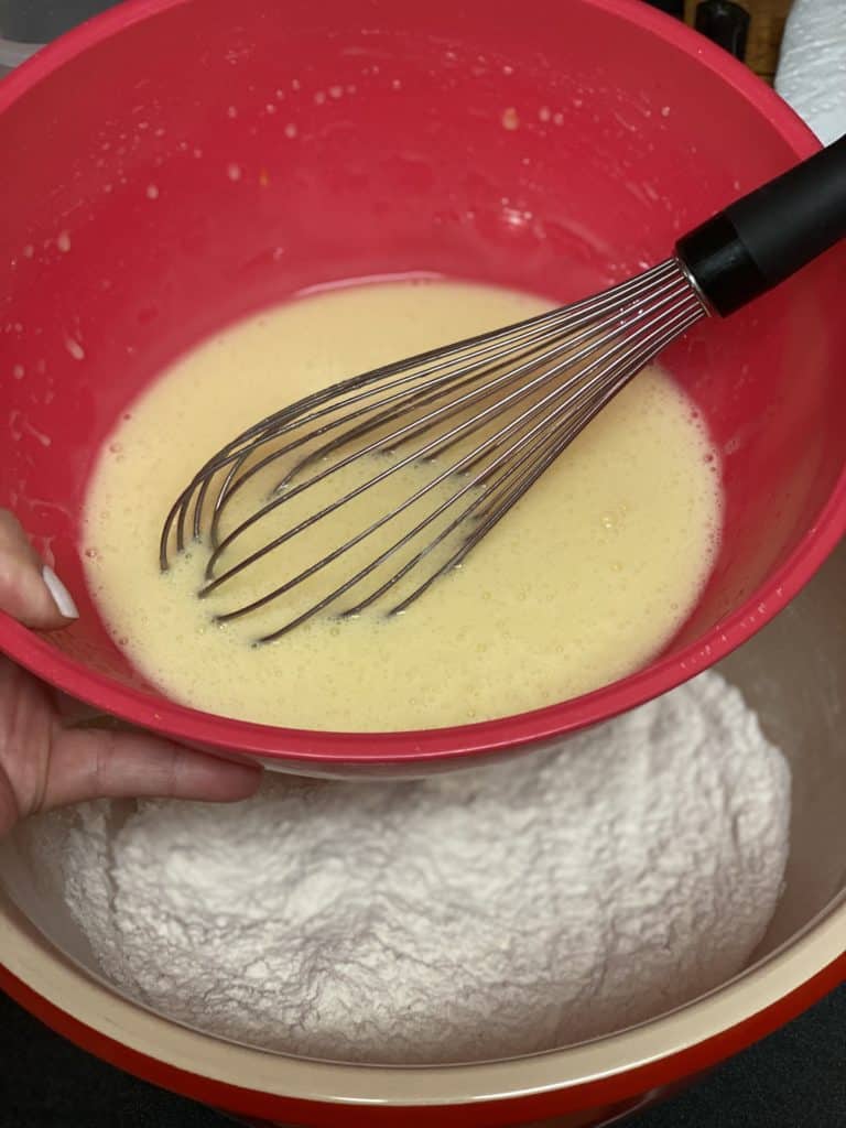 wet ingredients pouring into flour