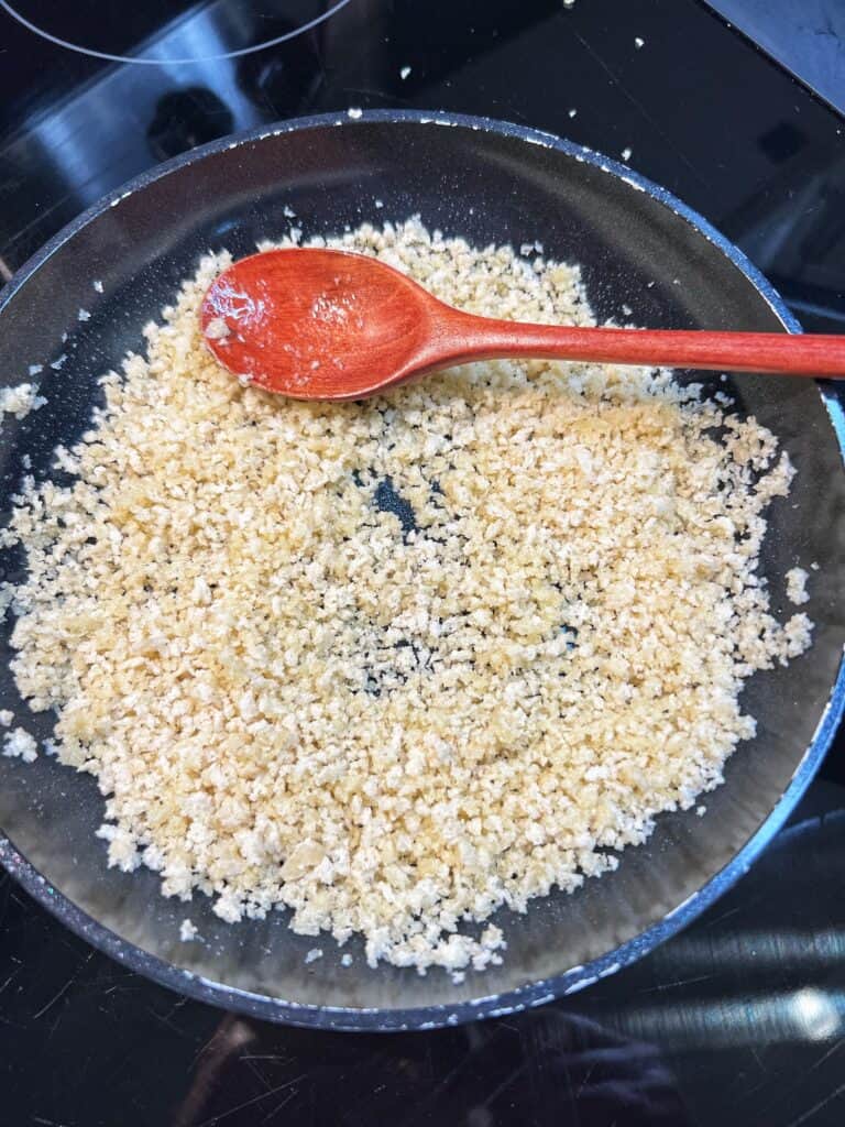 Toasting breadcrumbs in a small, non-stick pan.