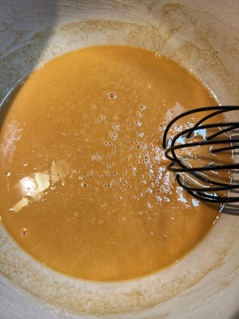 A roux that has been cooking for 30 minutes. It's showing a more pale brown color.