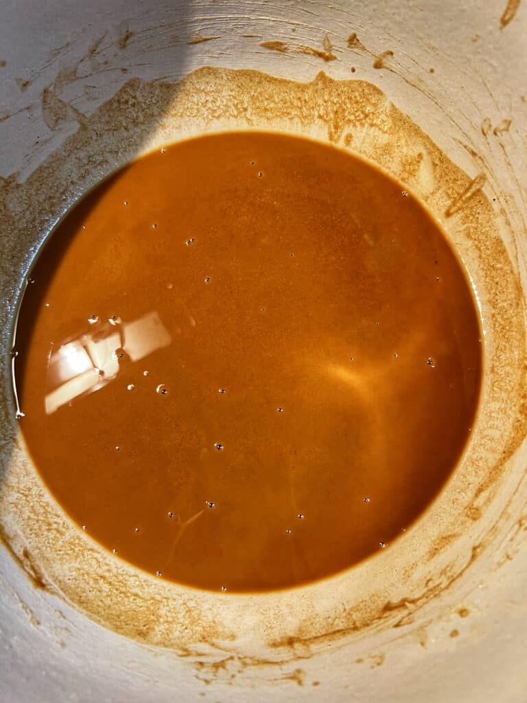 Roux in a pot at 38 minutes. The brown color is a lot deeper.