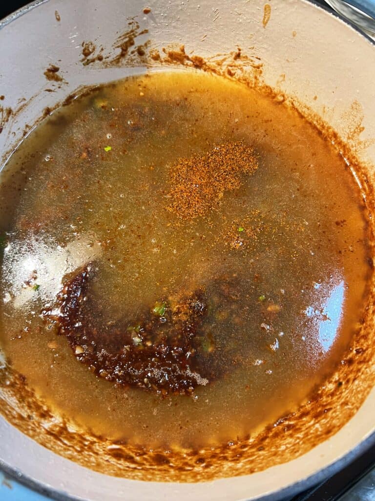 Chicken stock added to a dark roux.
