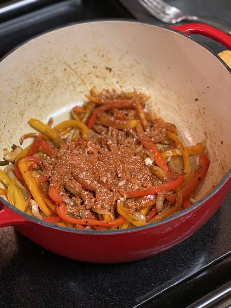 peppers and onions caramelized in a cast iron pot