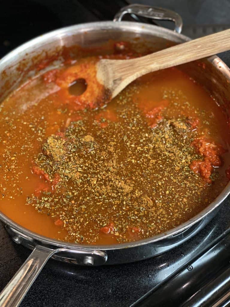 tomato sauce cooking in a pan with spices