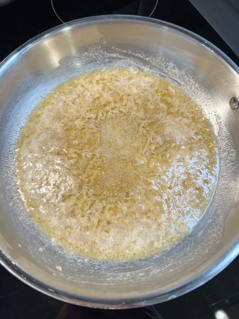 White wine added to sautéed, minced shallots and garlic and Old Bay for the filling for crab stuffed shrimp.