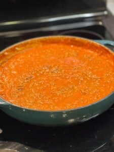 A pot of The Best Bolognese Sauce. The sauce is a rich, tomato-based sauce with meat.