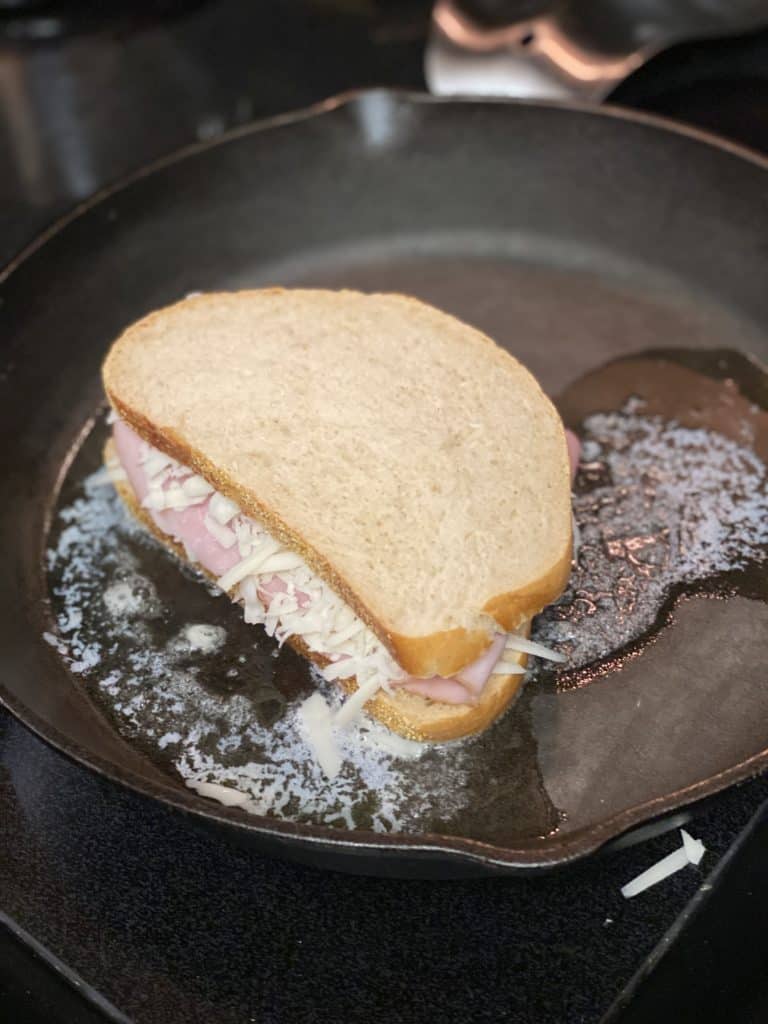 sandwiches for croque madame in a cast iron pan