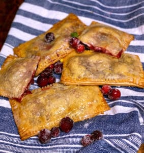 cranberry ricotta pop tarts on a blue and white cloth
