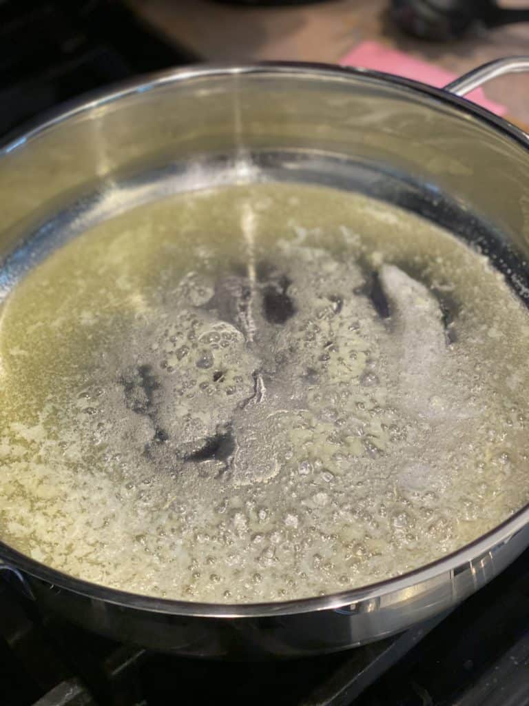 minced garlic sautéing in a pan of butter