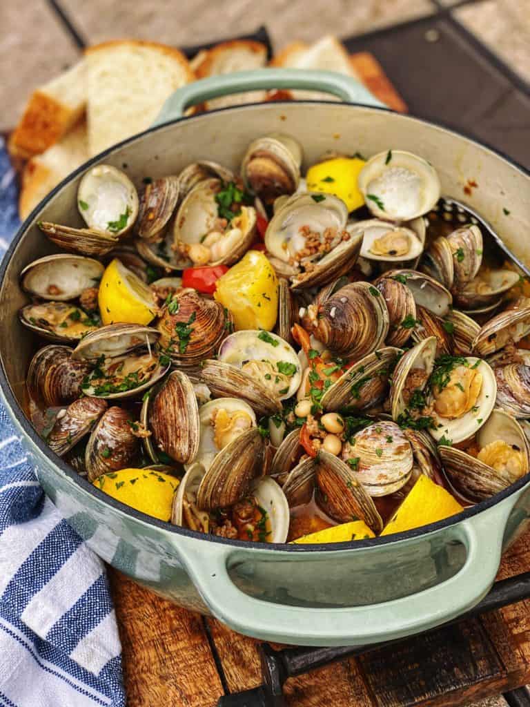 a pot of clams with sausage