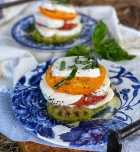 heirloom tomato caprese stacks on blue plates