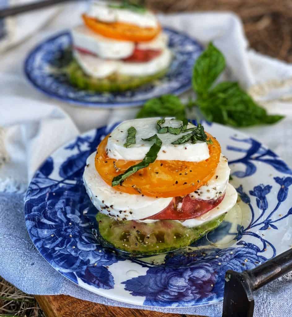 heirloom tomato caprese stacks on blue plates