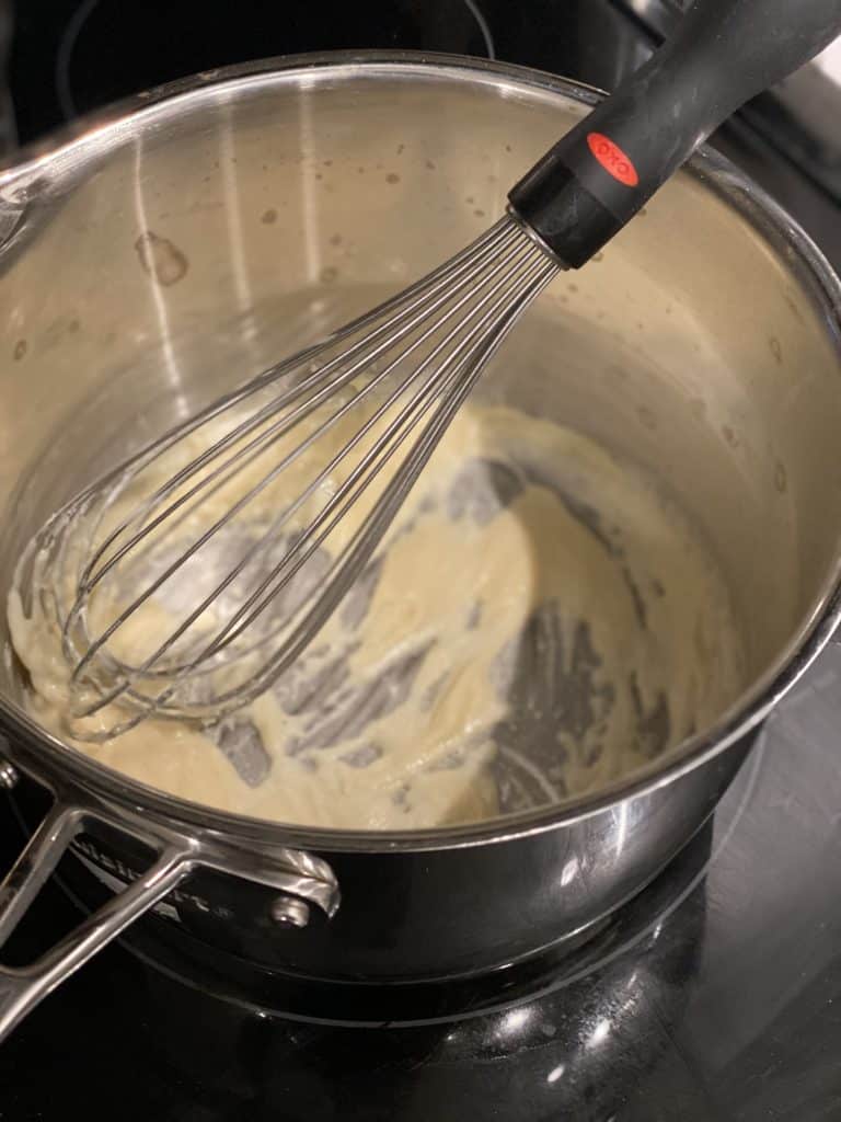 a roux of flour and butter in a saucepan with a whisk