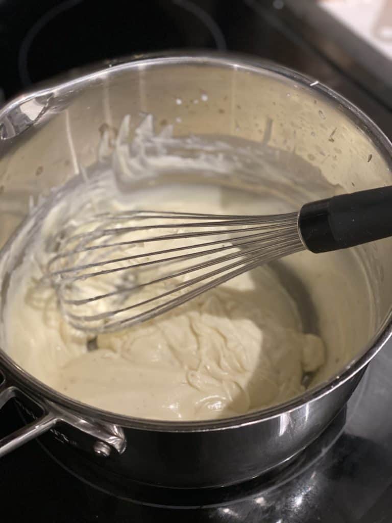 Béchamel in a saucepan with a whisk
