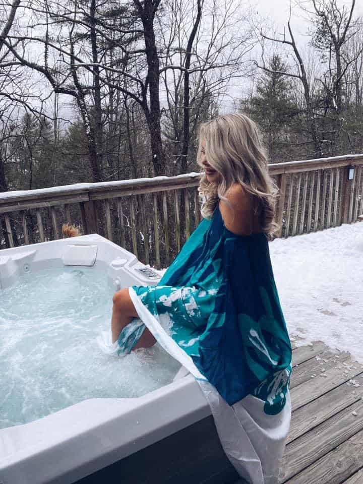 me sitting on the edge of a hot tub in a blue coverup