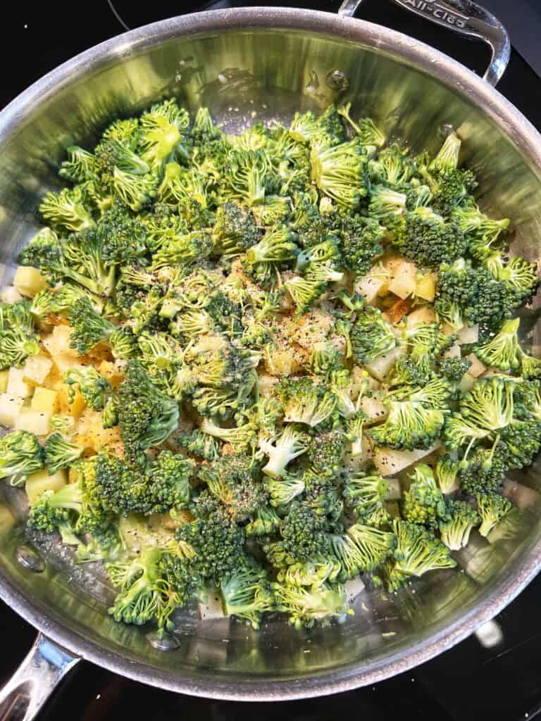 Cut up broccoli and tiny diced potatoes in a pan.